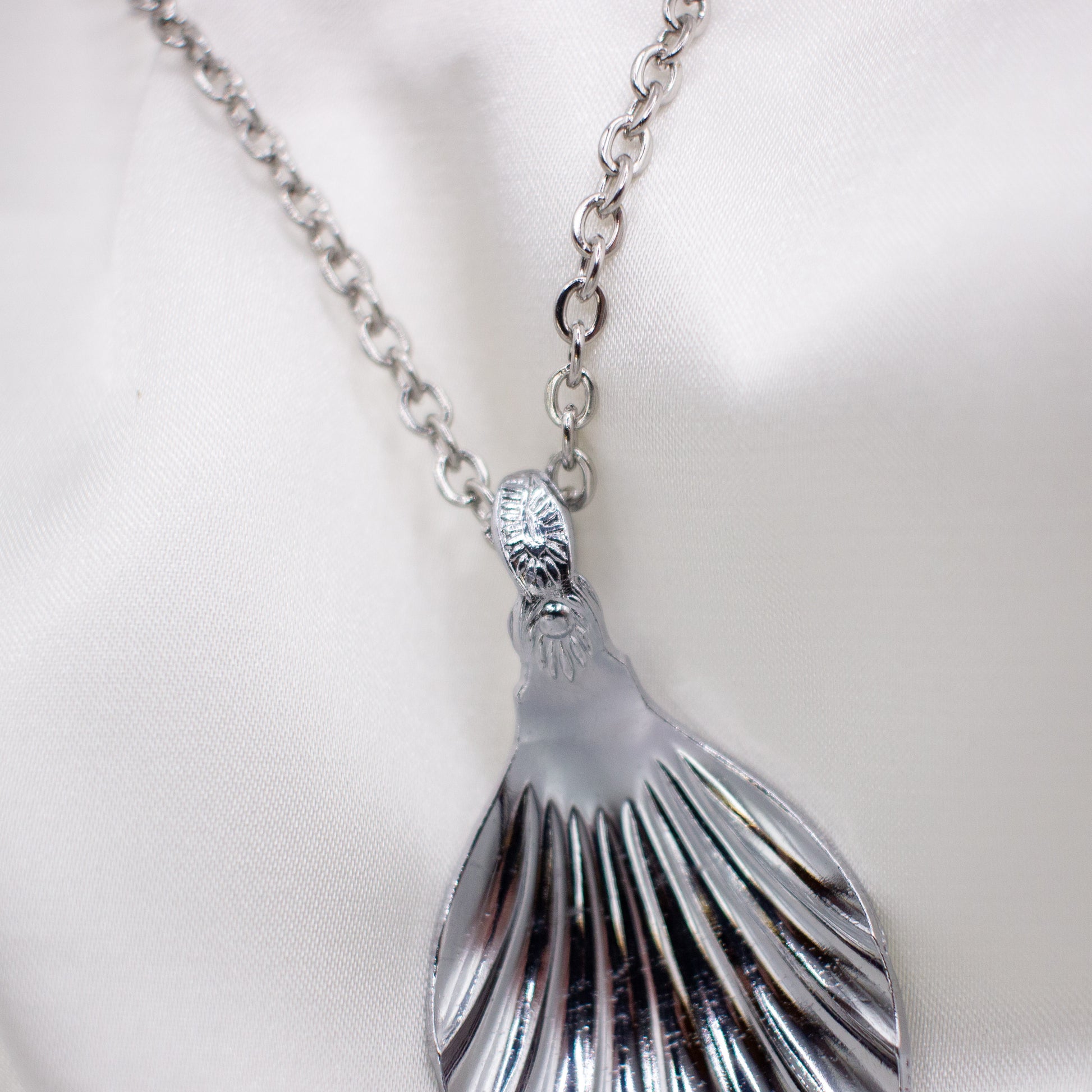spoon necklace against a white background